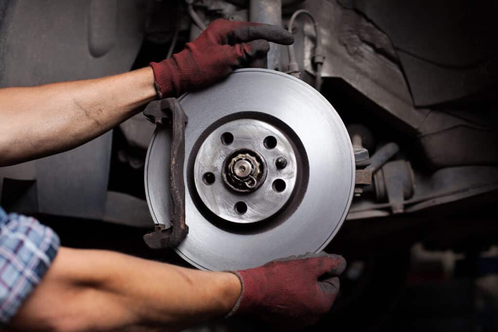 Car mechanic Repairing brakes on car. brakes work