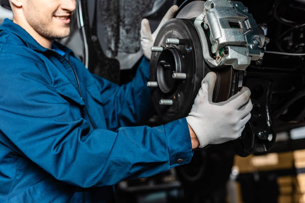 Cropped view of mechanic adjusting disc brakes. brakes work